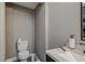Half-bathroom with toilet, sink, and speckled countertop at 6628 1St N St, St Petersburg, FL 33702