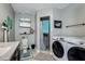 Bathroom featuring vanity, shower, and convenient in-unit laundry at 6628 1St N St, St Petersburg, FL 33702
