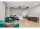 Bedroom with wood-like floors, a unique ceiling, and stylish green chairs at 6628 1St N St, St Petersburg, FL 33702