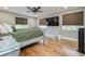 Main bedroom with ceiling fan, wood floors, and large bed at 6628 1St N St, St Petersburg, FL 33702