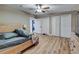 Spacious bedroom featuring wood-like floors, a ceiling fan, and closet doors at 6628 1St N St, St Petersburg, FL 33702