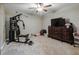 A bedroom with a ceiling fan, home gym, dresser, and TV at 6628 1St N St, St Petersburg, FL 33702