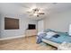A bedroom with light wood floors, a ceiling fan, and a large bed at 6628 1St N St, St Petersburg, FL 33702