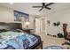 A bedroom with a bed, ceiling fan, gaming chair, and posters at 6628 1St N St, St Petersburg, FL 33702