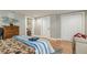 Bedroom featuring wooden floors, a bed with a striped comforter, and white doors at 6628 1St N St, St Petersburg, FL 33702