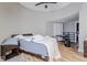 Cozy bedroom with wood-like floors, ceiling fan, and an attached office area at 6628 1St N St, St Petersburg, FL 33702