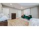Spacious bedroom with two green armchairs, wood floors, and a dresser at 6628 1St N St, St Petersburg, FL 33702