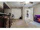 Spacious bedroom with ceiling fan, dresser, and open doorway at 6628 1St N St, St Petersburg, FL 33702