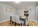 Dining area with view to the kitchen and wood-style flooring at 6628 1St N St, St Petersburg, FL 33702
