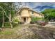 Tan two-story home with a unique rounded front and landscaping at 6628 1St N St, St Petersburg, FL 33702