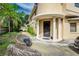 Front entry with a covered porch, wicker seating, and landscaping at 6628 1St N St, St Petersburg, FL 33702