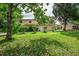 Sprawling front lawn with mature trees and lush greenery at 6628 1St N St, St Petersburg, FL 33702