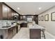 Modern kitchen with dark wood cabinets, stainless steel appliances, and granite countertops at 6628 1St N St, St Petersburg, FL 33702