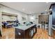 Kitchen with island, wood floors, and open view to living area at 6628 1St N St, St Petersburg, FL 33702