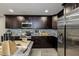 Updated kitchen boasting dark wood cabinets, granite countertops, and stainless steel appliances at 6628 1St N St, St Petersburg, FL 33702