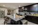Well-appointed kitchen with dark cabinetry, stainless steel appliances, and a granite-topped island at 6628 1St N St, St Petersburg, FL 33702
