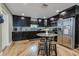 Kitchen with dark wood cabinets, stainless steel appliances, and a breakfast nook with bar stools at 6628 1St N St, St Petersburg, FL 33702