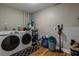 Laundry room with Samsung washer and dryer, storage shelves, and cleaning supplies at 6628 1St N St, St Petersburg, FL 33702