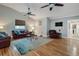 Living room with wood-style floors, leather furniture, ceiling fan, and area rug at 6628 1St N St, St Petersburg, FL 33702
