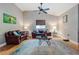 Living room featuring wood-style flooring, ceiling fan, and leather furniture at 6628 1St N St, St Petersburg, FL 33702