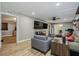 Living room with wood floors, ceiling fan, and view to bedroom at 6628 1St N St, St Petersburg, FL 33702