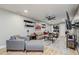 Living area with sofa, entertainment center, and view to kitchen and laundry at 6628 1St N St, St Petersburg, FL 33702