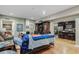 Living room with entertainment center, wood floors, and open view of the kitchen at 6628 1St N St, St Petersburg, FL 33702