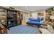 Living room featuring entertainment center, comfortable seating, and sports decor at 6628 1St N St, St Petersburg, FL 33702