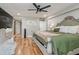 Large main bedroom featuring a ceiling fan, artwork, and hardwood floors at 6628 1St N St, St Petersburg, FL 33702
