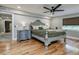 Spacious main bedroom with a ceiling fan, elegant bed, and wood floors at 6628 1St N St, St Petersburg, FL 33702