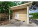 Outdoor shed with double doors near a wooden fence and water view at 6628 1St N St, St Petersburg, FL 33702