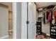 Organized walk-in closet with hanging clothes, shelves, and shoes at 6628 1St N St, St Petersburg, FL 33702