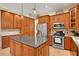 Modern kitchen with stainless steel appliances and wood cabinetry at 8608 Poinsettia Dr, Temple Terrace, FL 33637