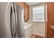 Well-equipped laundry room with full-size appliances at 8608 Poinsettia Dr, Temple Terrace, FL 33637