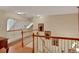 Upstairs hallway with hardwood floors and elegant artwork at 8608 Poinsettia Dr, Temple Terrace, FL 33637