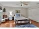 Cozy bedroom with hardwood floors and a ceiling fan at 8608 Poinsettia Dr, Temple Terrace, FL 33637