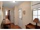 Charming hallway with wood-look tile flooring and rustic wooden console table at 8608 Poinsettia Dr, Temple Terrace, FL 33637