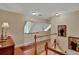 Upstairs hallway with wood floors and a red carpet runner at 8608 Poinsettia Dr, Temple Terrace, FL 33637