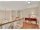 Spacious upper hallway with hardwood floors and a view of the staircase at 8608 Poinsettia Dr, Temple Terrace, FL 33637