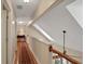 Upstairs hallway with wood floors and a red carpet runner at 8608 Poinsettia Dr, Temple Terrace, FL 33637