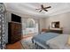 Large Primary bedroom with hardwood floors and a picturesque window at 8608 Poinsettia Dr, Temple Terrace, FL 33637
