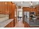 Kitchen with granite countertops, stainless steel appliances, and wood cabinets at 8608 Poinsettia Dr, Temple Terrace, FL 33637