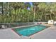 Inviting swimming pool with brick coping and surrounding lush greenery at 8608 Poinsettia Dr, Temple Terrace, FL 33637