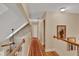 Upstairs hallway with wood floors, stone wall, and ceiling fan at 8608 Poinsettia Dr, Temple Terrace, FL 33637