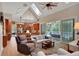 Open living room with hardwood floors, access to pool, and kitchen view at 8608 Poinsettia Dr, Temple Terrace, FL 33637