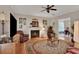 Cozy living room with hardwood floors, a fireplace, and leather armchairs at 8608 Poinsettia Dr, Temple Terrace, FL 33637