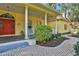 Inviting front porch with red door, white columns, and brick walkway at 8608 Poinsettia Dr, Temple Terrace, FL 33637