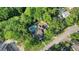 House nestled in a wooded neighborhood with a pool at 8608 Poinsettia Dr, Temple Terrace, FL 33637