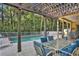 Pergola-covered patio overlooking the pool and backyard at 8608 Poinsettia Dr, Temple Terrace, FL 33637