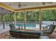 Relaxing pool area with covered patio and comfortable seating at 8608 Poinsettia Dr, Temple Terrace, FL 33637